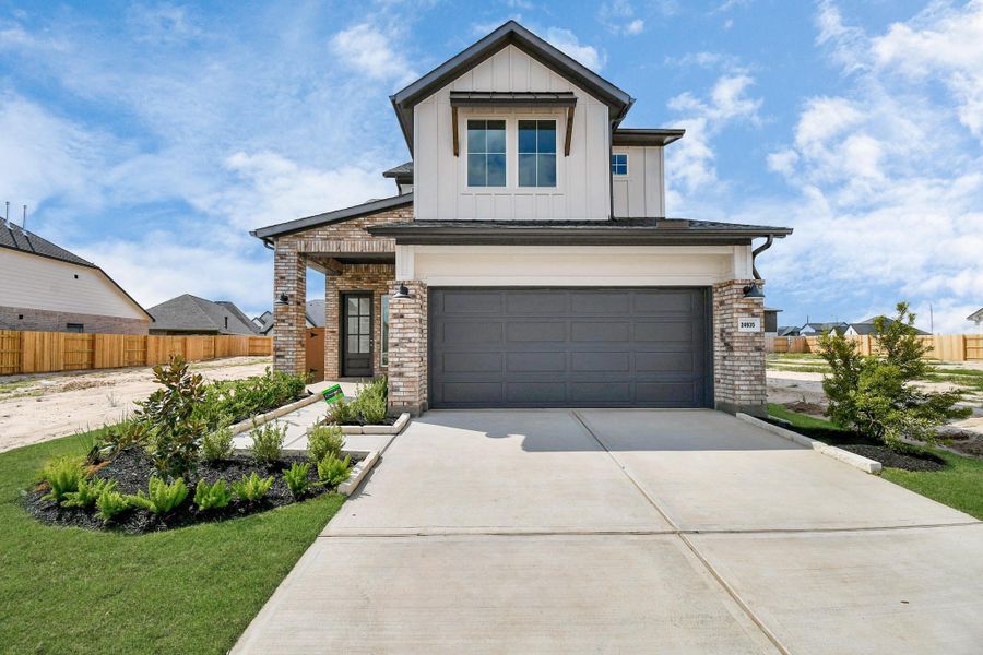 Front exterior of a new home in Elyson, Katy, TX, highlighting curb appeal (Image 23).