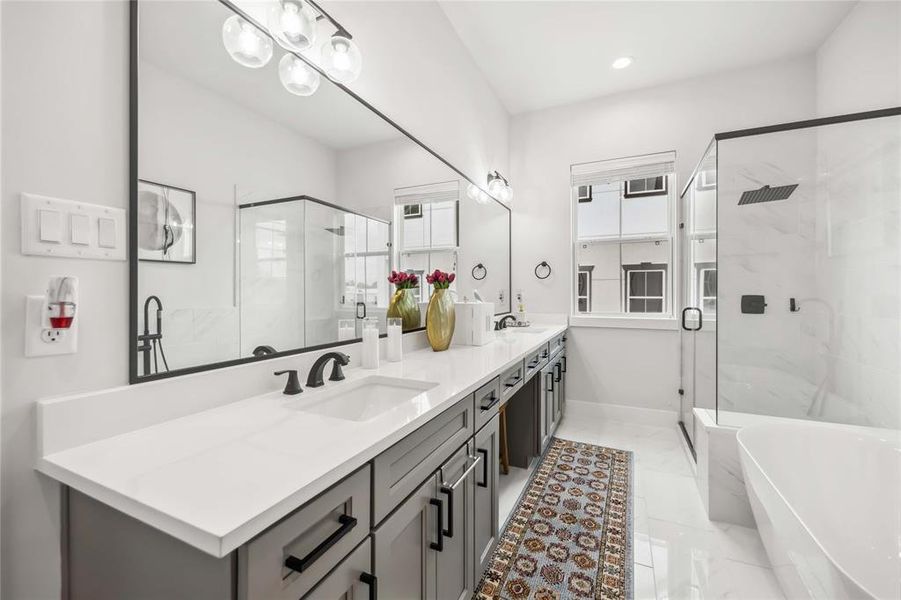 Beautiful and bright Primary Bathroom with lots of storage, spacious rain shower and modern tub.