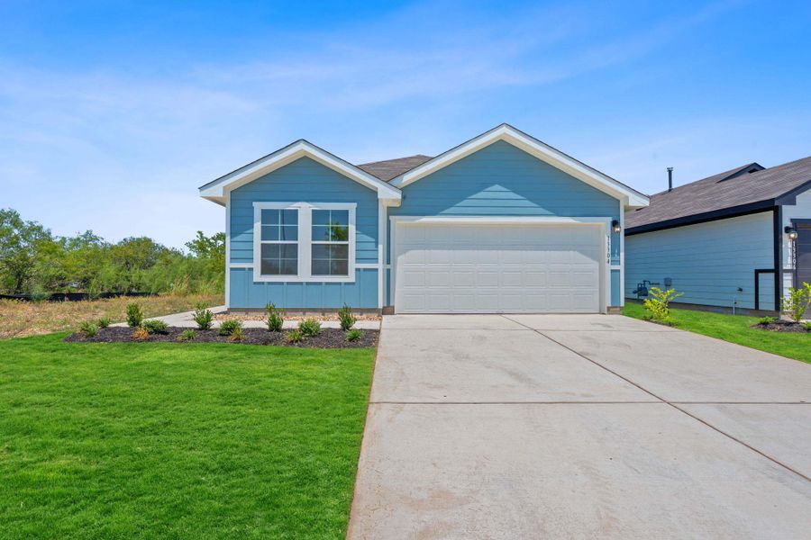 Single story home with a garage, a front yard, and driveway Single story home with a garage, a front yard, and driveway