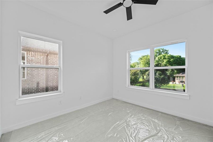 Carpeted empty room featuring a ceiling fan and baseboards Carpeted empty room featuring a ceiling fan and baseboards