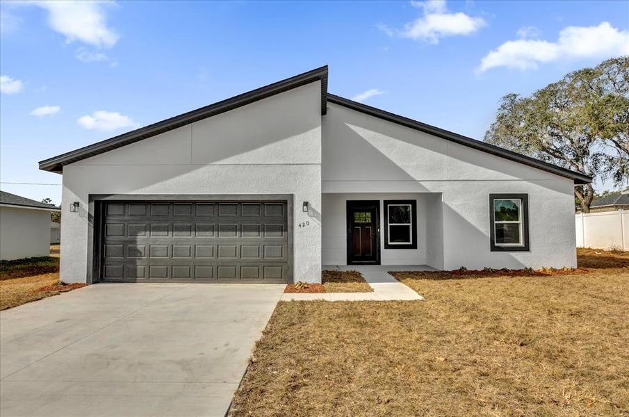 Front exterior of a new home in , Ocala, FL, highlighting curb appeal (Image 1).