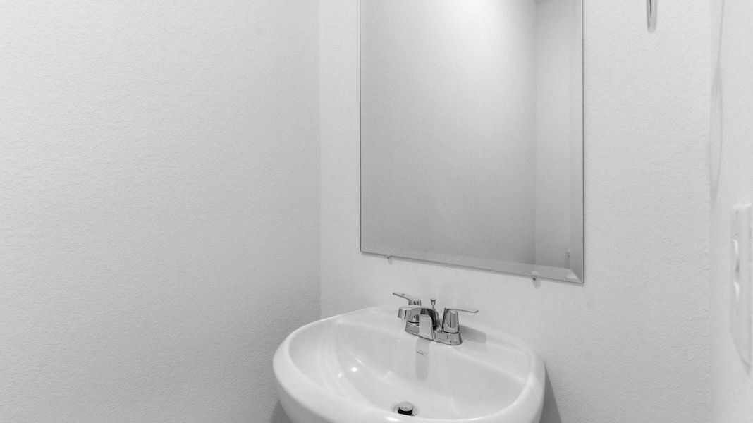 A decorated half bathroom downstairs for guests