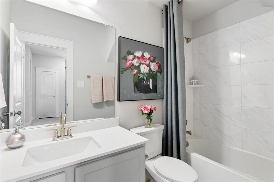 Full bathroom with vanity, toilet, and shower / tub combo