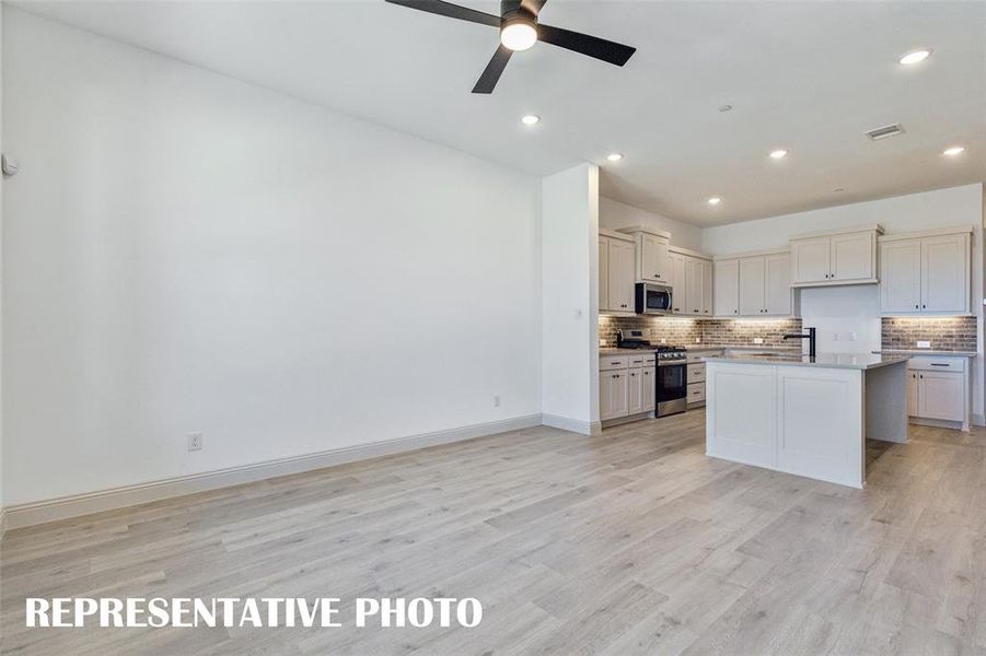 Our Sunny Interior plan features an open concept kitchen-family-dining area that is perfect for entertaining family & friends!  REPRESENTATIVE PHOTO