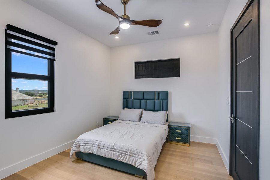 Bedroom with light wood-style flooring, recessed lighting, and a ceiling fan Bedroom with light wood-style flooring, recessed lighting, and a ceiling fan
