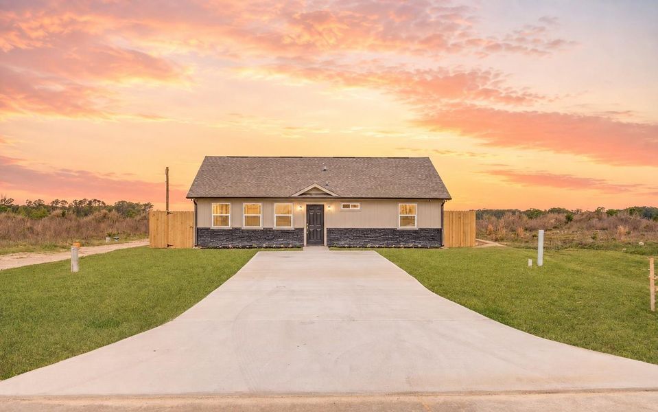 A charming home beneath a beautiful Texas sunset. With extra long driveway. (Sky Virtually Enhanced)
