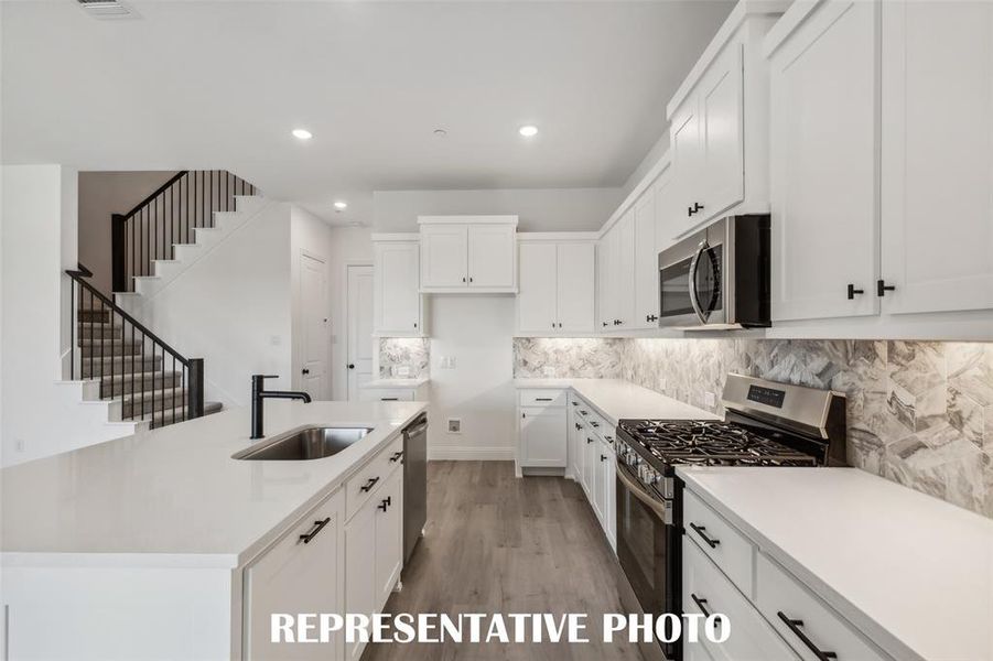 Beautiful cabinetry, gorgeous countertops and designer backsplash paired with contemporary stainless steel come together to create the kitchen of your dreams in our Helaina plan! REPRESENTATIVE PHOTO Beautiful cabinetry, gorgeous countertops and designer backsplash paired with contemporary stainless steel come together to create the kitchen of your dreams in our Helaina plan! REPRESENTATIVE PHOTO