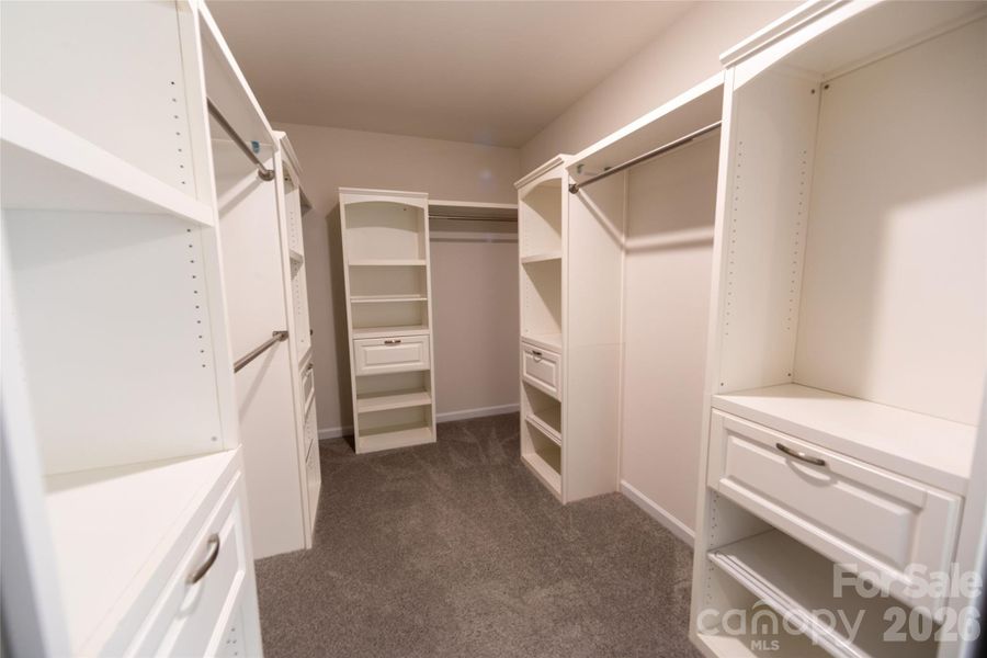 Generous closet with built-in shelving and ample storage.