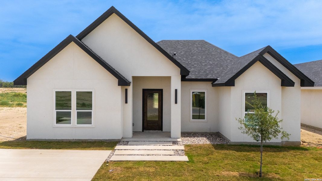 Front exterior of a new home in , Eagle Pass, TX, highlighting curb appeal (Image 1). Front exterior of a new home in , Eagle Pass, TX, highlighting curb appeal (Image 1).