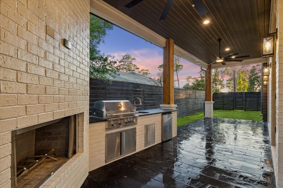 Outdoor fireplace, outdoor kitchen, tongue and groove stained wood ceiling complete these dream back patio space*Picture is of a recently constructed home by the builder.  1519 Candlelight will be similar in quality, but these pictures are not meant to be an exact representation of the new home. Specs of home may change at sole discretion of the seller.