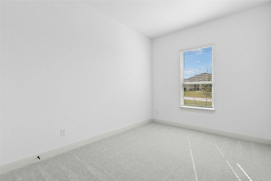 Spare room featuring carpet flooring and baseboards Spare room featuring carpet flooring and baseboards