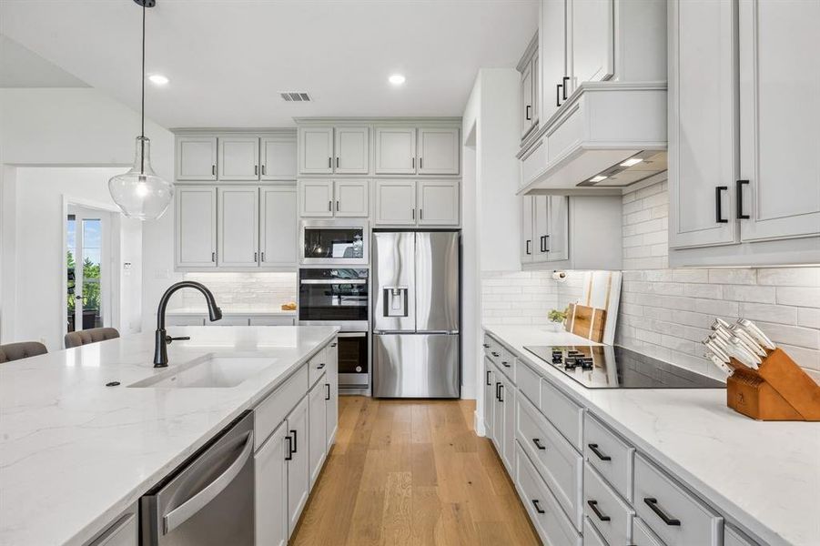 This kitchen is a showstopper with so much cabinet space & quartz counters.