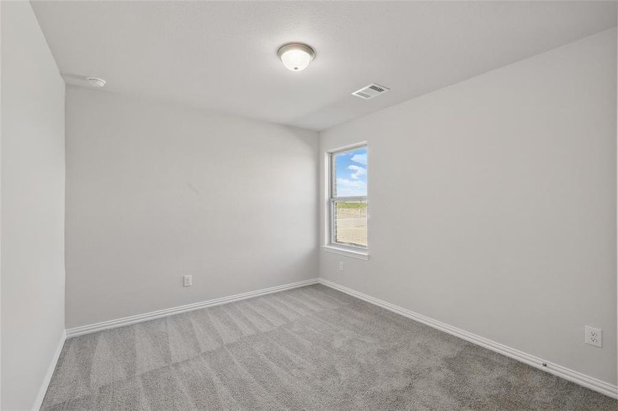 Spare room featuring carpet floors and a smoke detector Spare room featuring carpet floors and a smoke detector