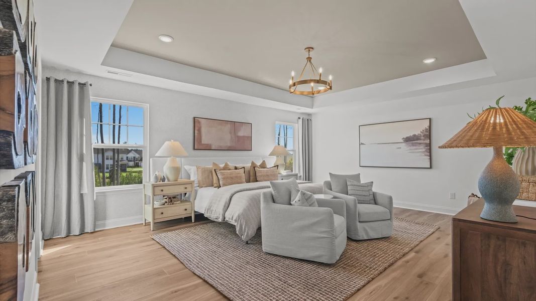 Wynwood home plan expansive primary suite with tray ceiling, sitting room, walk-in closet, and luxury en suite bathroom Wynwood home plan expansive primary suite with tray ceiling, sitting room, walk-in closet, and luxury en suite bathroom
