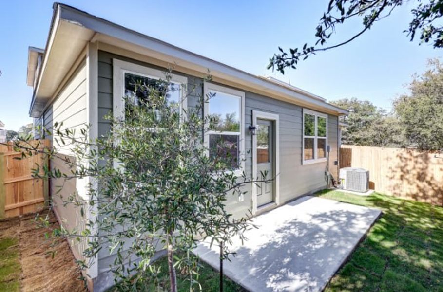 A house with a tree in the front yard. A house with a tree in the front yard.