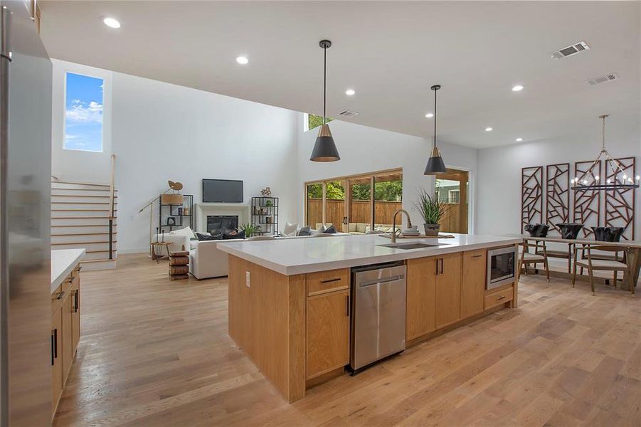 Kitchen with a sink, appliances with stainless steel finishes, light countertops, light wood finished floors, and recessed lighting Kitchen with a sink, appliances with stainless steel finishes, light countertops, light wood finished floors, and recessed lighting
