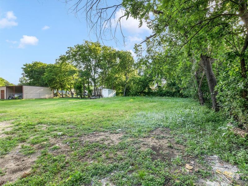 View of green lawn featuring an outdoor structure View of green lawn featuring an outdoor structure