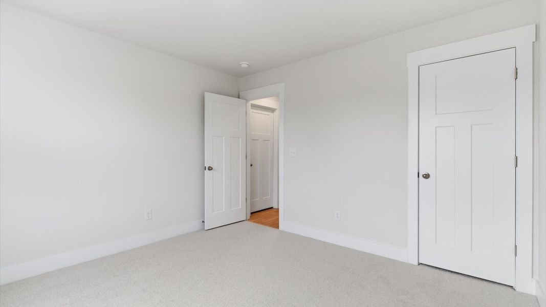 First-rate secondary bedroom with a spacious walk-in closet and elegant carpeted flooring located in Greenville, SC
