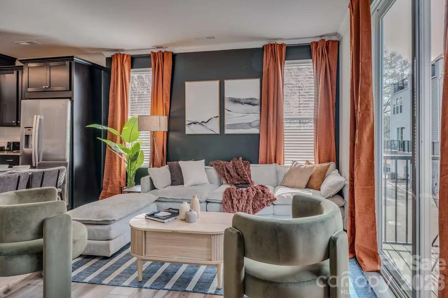 The inviting living room features abundant natural light, stylish modern finishes, and an open-concept design that flows seamlessly to the private balcony, creating the perfect space for relaxing or entertaining. The inviting living room features abundant natural light, stylish modern finishes, and an open-concept design that flows seamlessly to the private balcony, creating the perfect space for relaxing or entertaining.