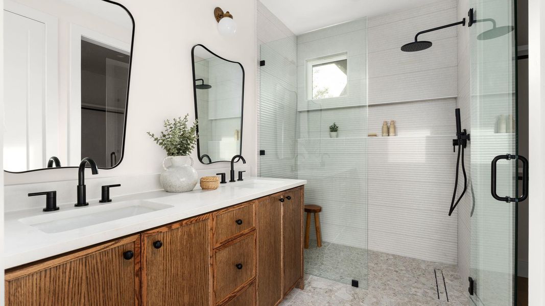 Full bathroom with a shower stall and double vanity