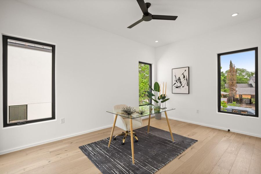 Office area with light wood-style flooring, recessed lighting, and ceiling fan