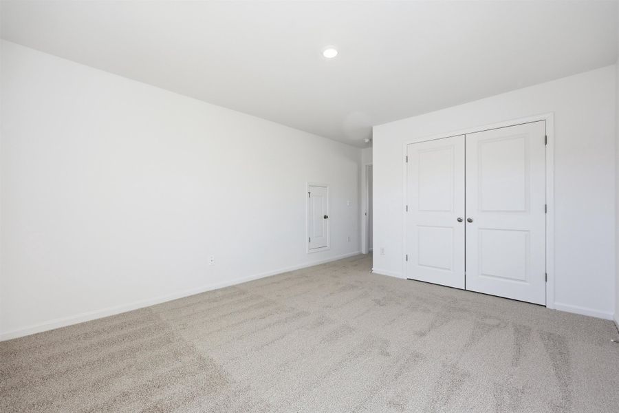 Unfurnished bedroom featuring carpet floors and a closet Unfurnished bedroom featuring carpet floors and a closet