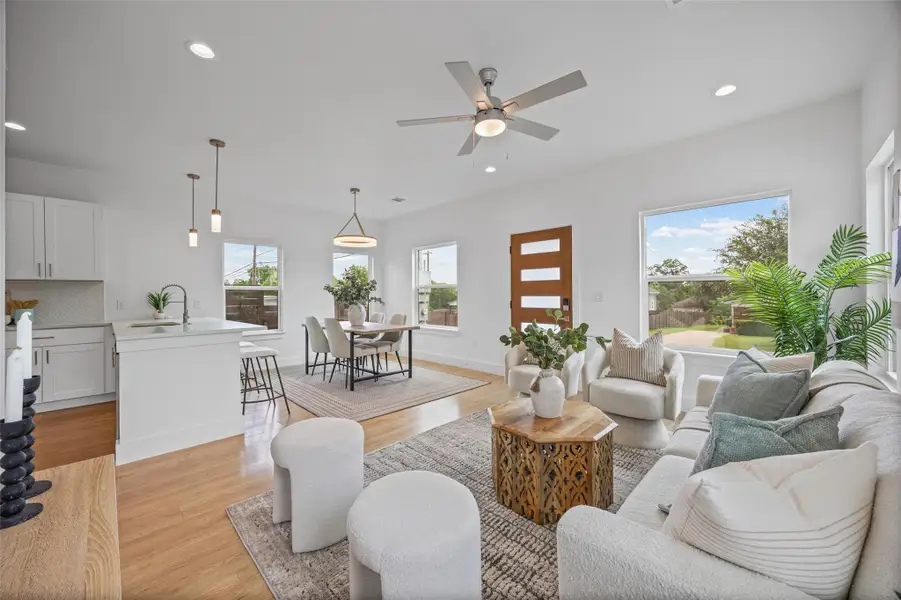 An open concept living and dining area boasts gleaming hardwood floors and abundant natural light. An open concept living and dining area boasts gleaming hardwood floors and abundant natural light.