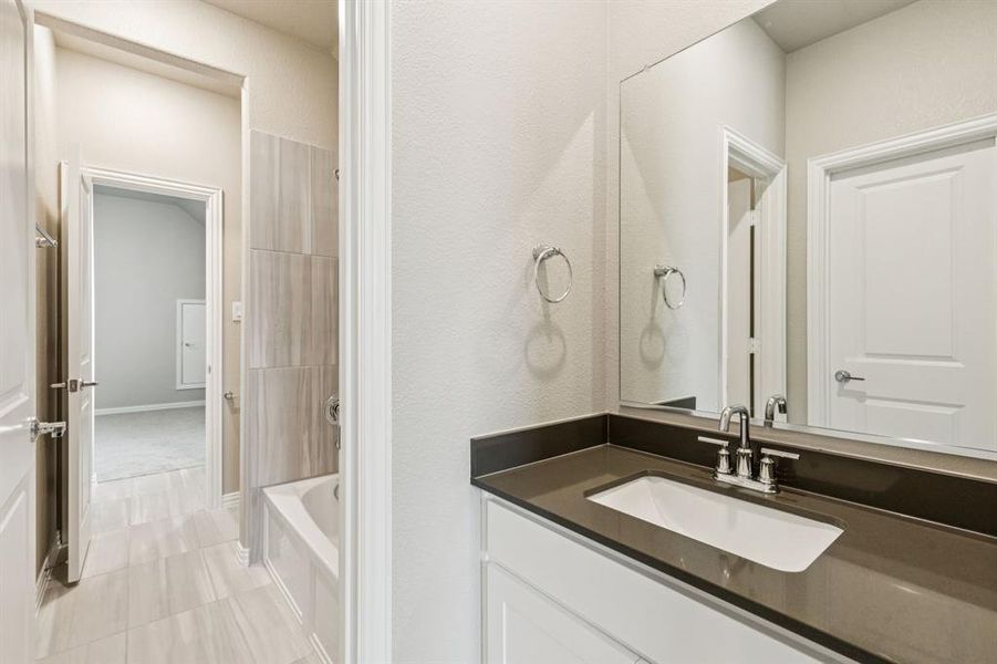 Bathroom with vanity and tile patterned flooring