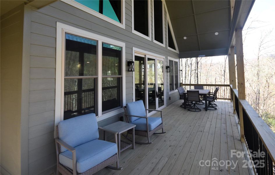 Covered walkway leads to the covered front deck/porch