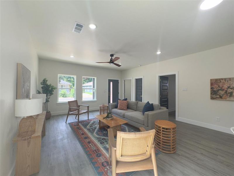 Living room with ceiling fan and wood-type flooring