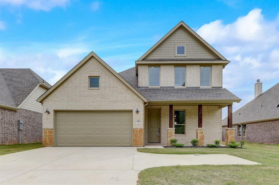 Craftsman-style home with a front lawn and a garage