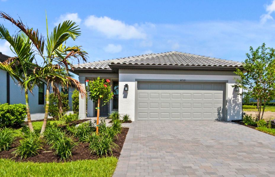Front exterior of a new home in Arbor Oaks, North Port, FL, highlighting curb appeal (Image 2). Front exterior of a new home in Arbor Oaks, North Port, FL, highlighting curb appeal (Image 2).