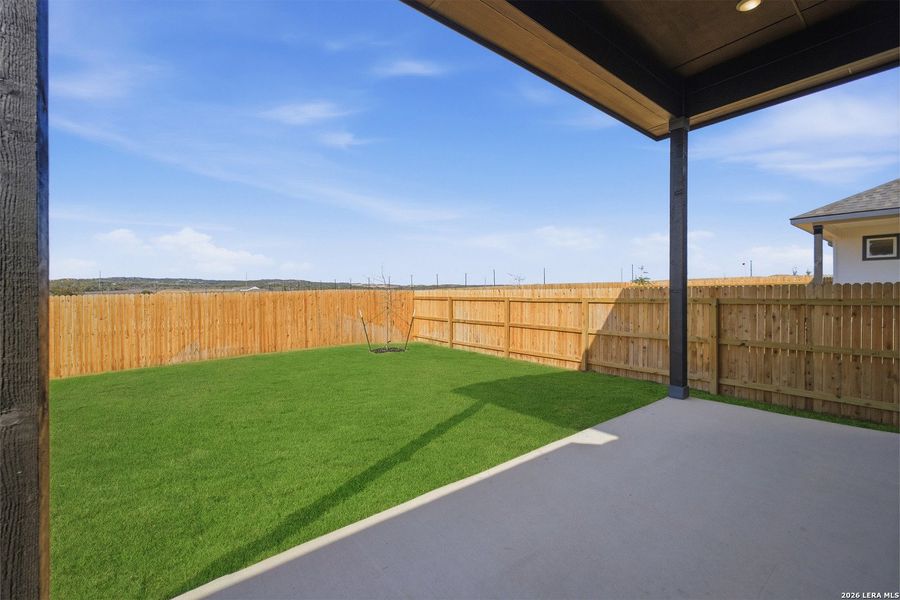 Exterior details and patio area of a home in The Woodlands at Medina Hills, Mico (Image 25).