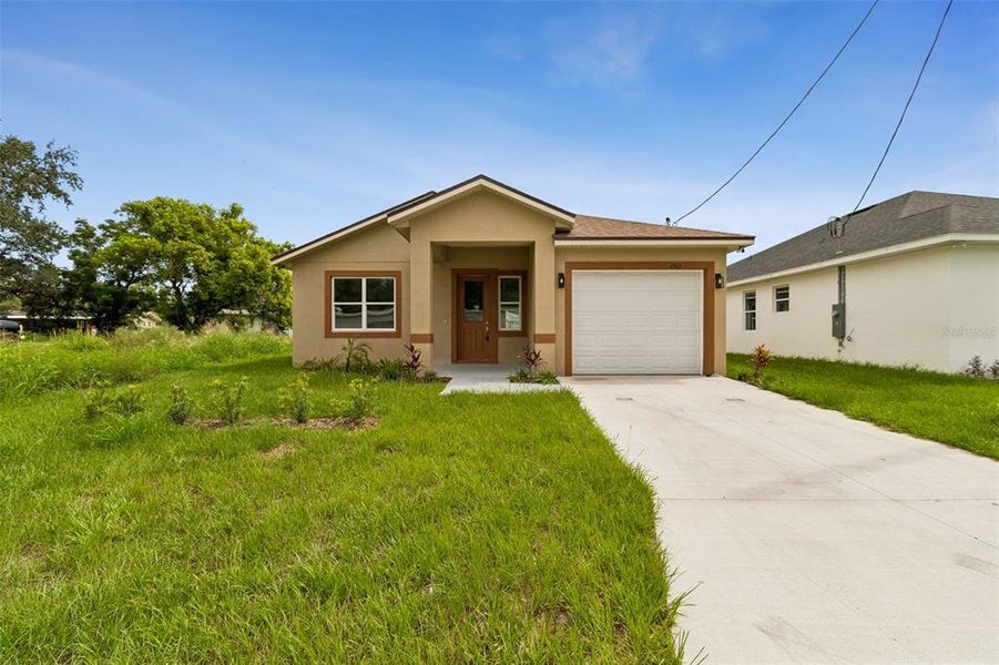 Front exterior of a new home in , Winter Haven, FL, highlighting curb appeal (Image 1). Front exterior of a new home in , Winter Haven, FL, highlighting curb appeal (Image 1).
