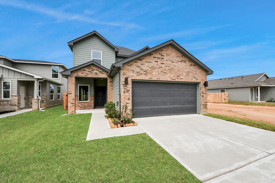 Front exterior of a new home in The Enclave at Spring Branch, Montgomery, TX, highlighting curb appeal (Image 25). Front exterior of a new home in The Enclave at Spring Branch, Montgomery, TX, highlighting curb appeal (Image 25).