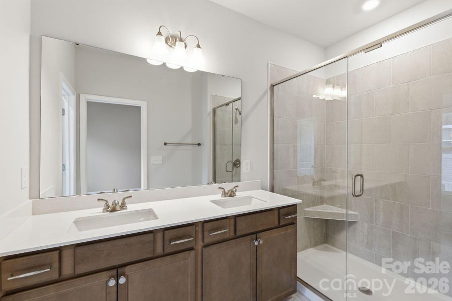 Primary Bathroom with Tile Walk-in Shower, featuring linen closet and private water closet Primary Bathroom with Tile Walk-in Shower, featuring linen closet and private water closet