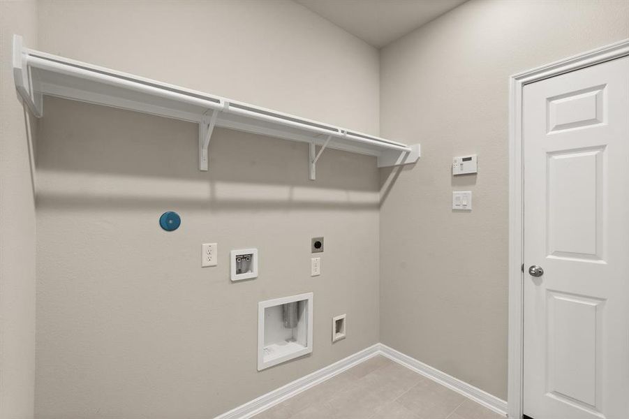 The laundry room layout is carefully planned for optimal workflow with designated areas for washing, drying, and storing.