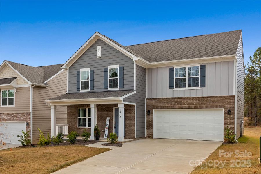 Front exterior of a new home in Creekside Cottages, Bessemer City, NC, highlighting curb appeal (Image 2).