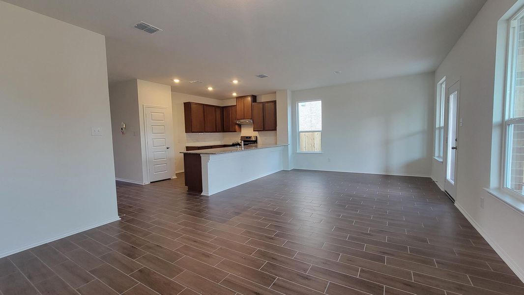 Unfurnished living room with wood tiled floors and recessed lighting