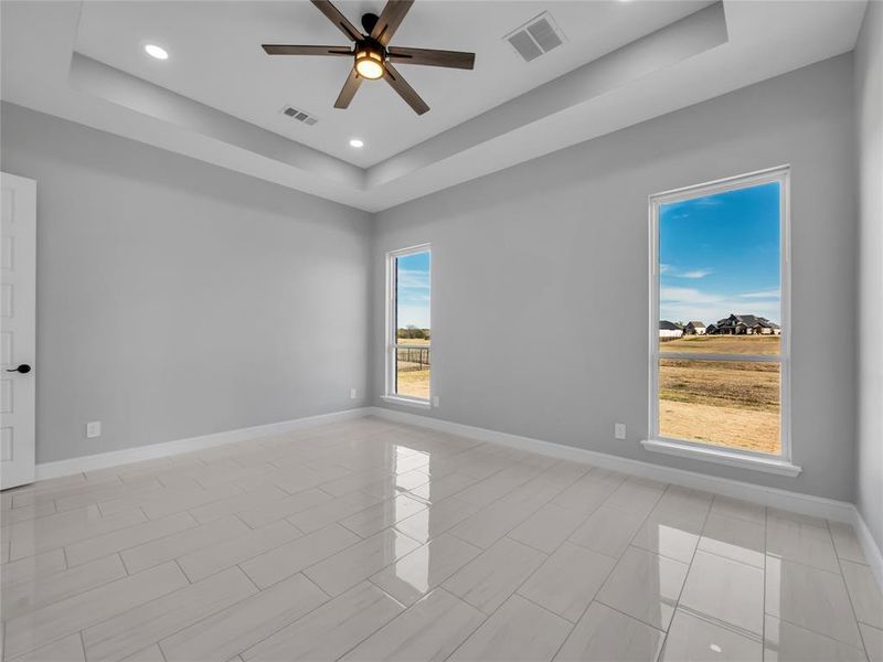 Primary bedroom with vaulted ceiling and lots of natural light. Primary bedroom with vaulted ceiling and lots of natural light.