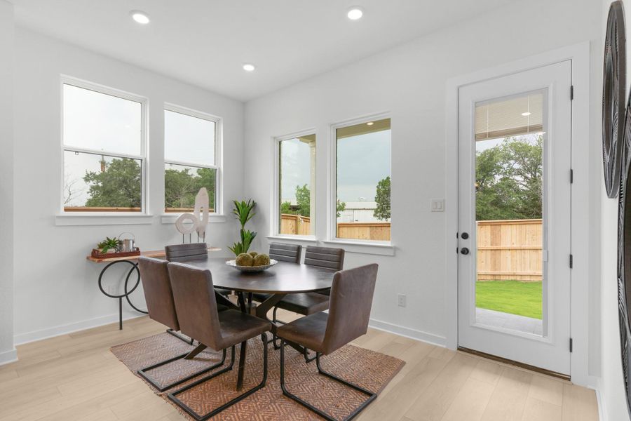Dining space featuring light wood finished floors, recessed lighting, and baseboards