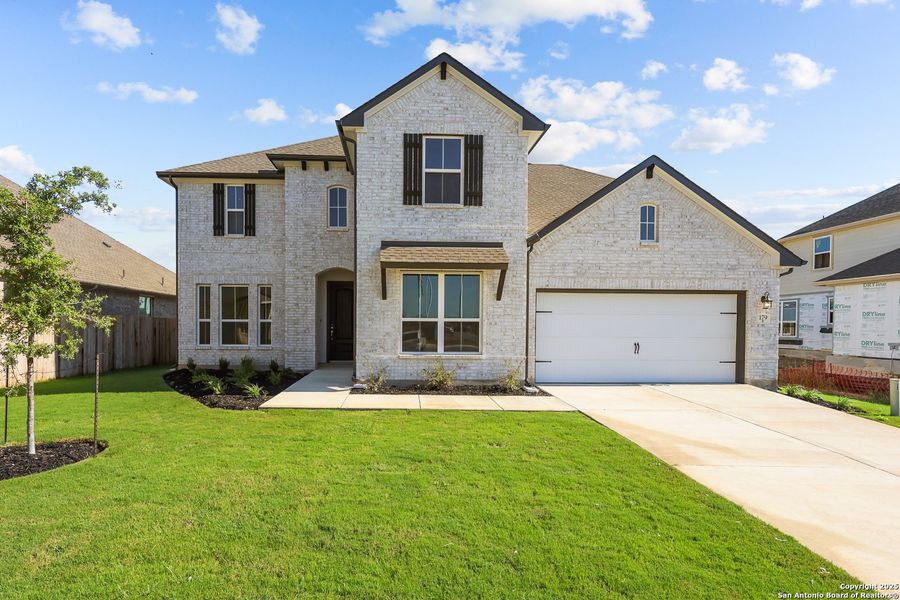 Front exterior of a new home in Megan's Landing 50', Castroville, TX, highlighting curb appeal (Image 18).