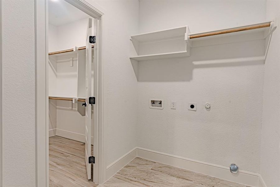 Laundry room connects to both hallway and primary closet