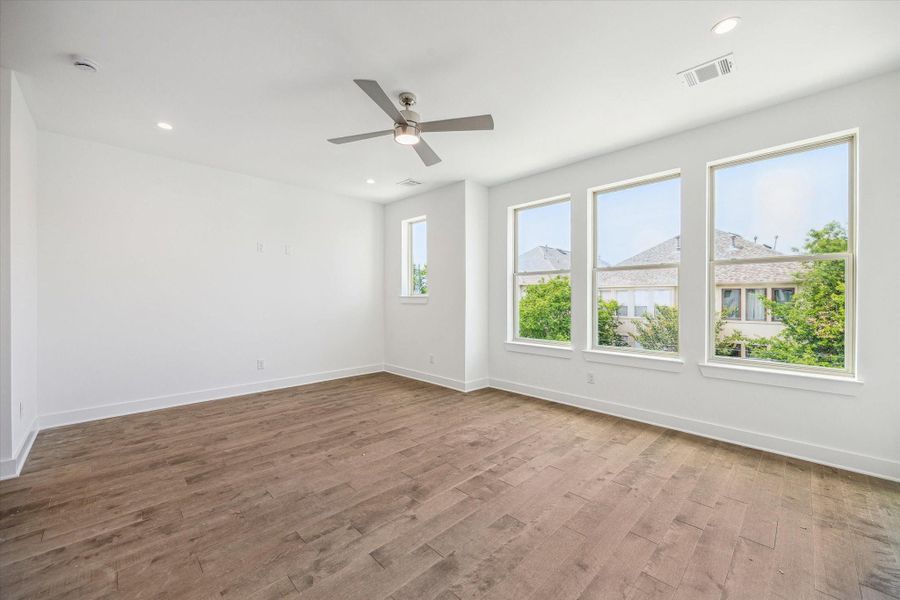 HUGE Primary Bedroom * Sitting Area * Wall of Windows * Hardwood Floors * Recessed Lighting * Modern Ceiling Fan with Light. HUGE Primary Bedroom * Sitting Area * Wall of Windows * Hardwood Floors * Recessed Lighting * Modern Ceiling Fan with Light.