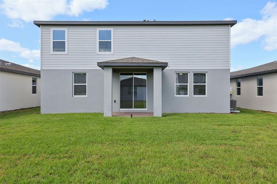 Exterior details and patio area of a home in The Reserve at Twin Lakes, St. Cloud (Image 4).