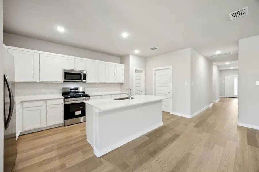 Kitchen in the Oscar home plan by Trophy Signature Homes – REPRESENTATIVE PHOTO