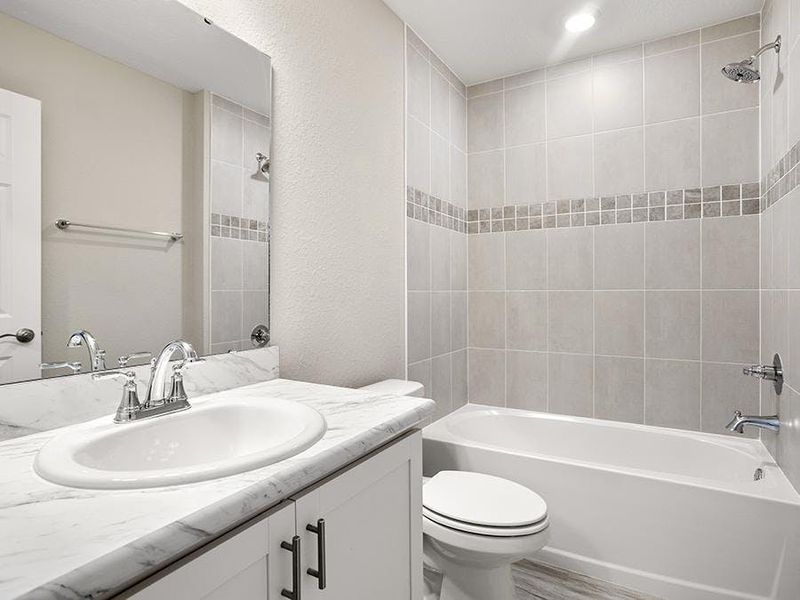 Secondary bedrooms and guests share a convenient hall bath - Sophia by Highland Homes