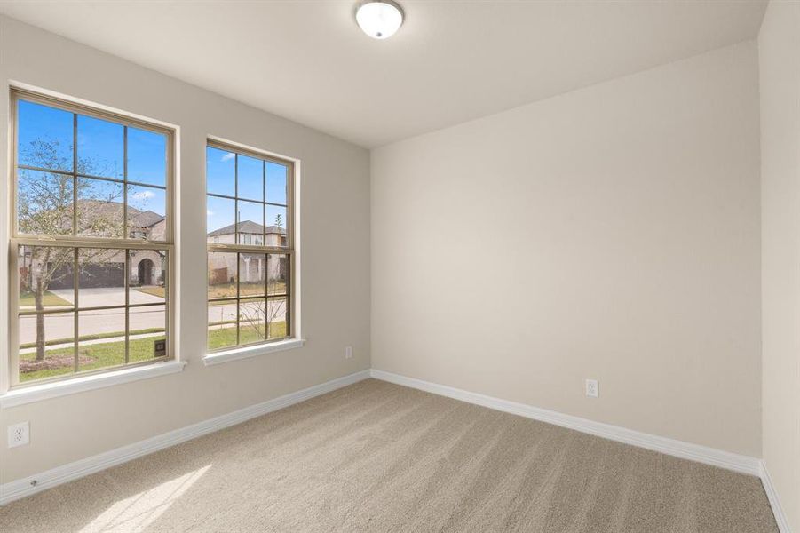 Your secondary bedroom features plush carpet, fresh paint, closet, and a large window that lets in plenty of natural lighting.