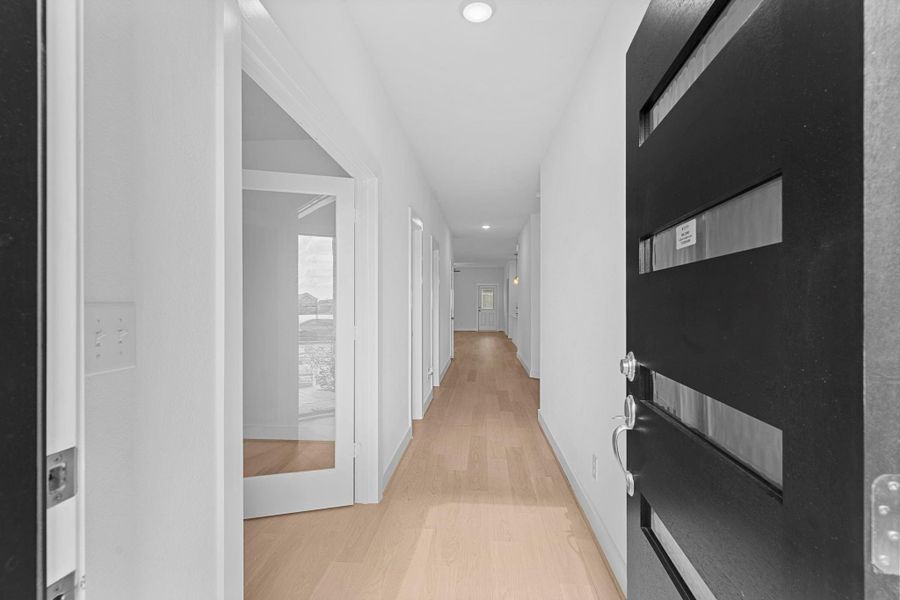 Step inside and be greeted by a light-filled hallway with elegant wood-look tile flooring that stretches throughout the main living areas. The soft lighting and open flow create a warm and welcoming feel, leading you toward the spacious family room and kitchen. This inviting space instantly makes you feel at ease — a place where memories are waiting to be made! **Image Representative of Plan Only and May Vary as Built**.