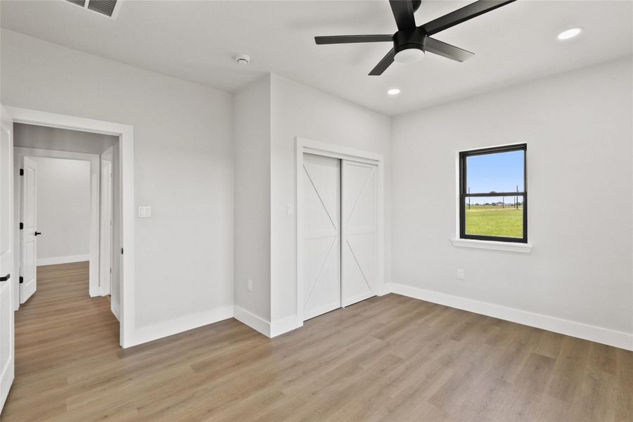 Additional secondary bedroom located near the full guest bathroom, offering flexibility for guests, hobbies, or everyday living. Includes a closet and ample natural light.